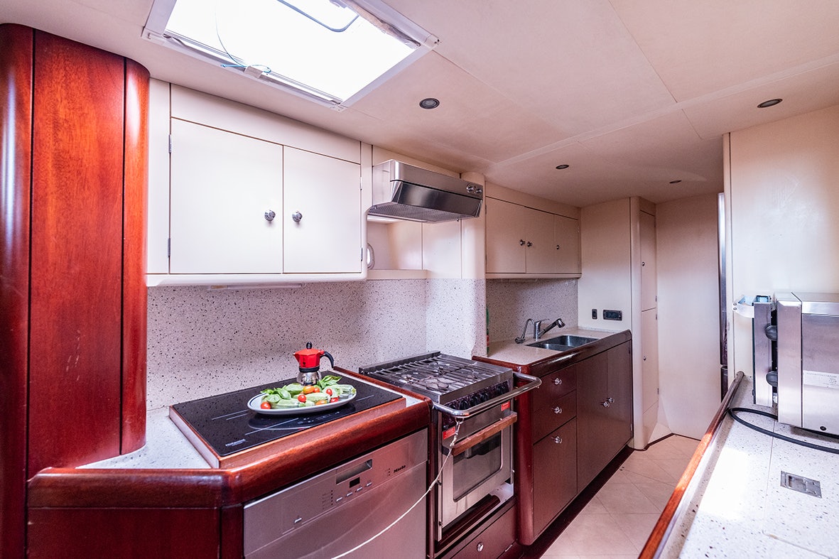 a kitchen with a stove and oven aboard CYGNUS OF ANGLESEY Yacht for Sale