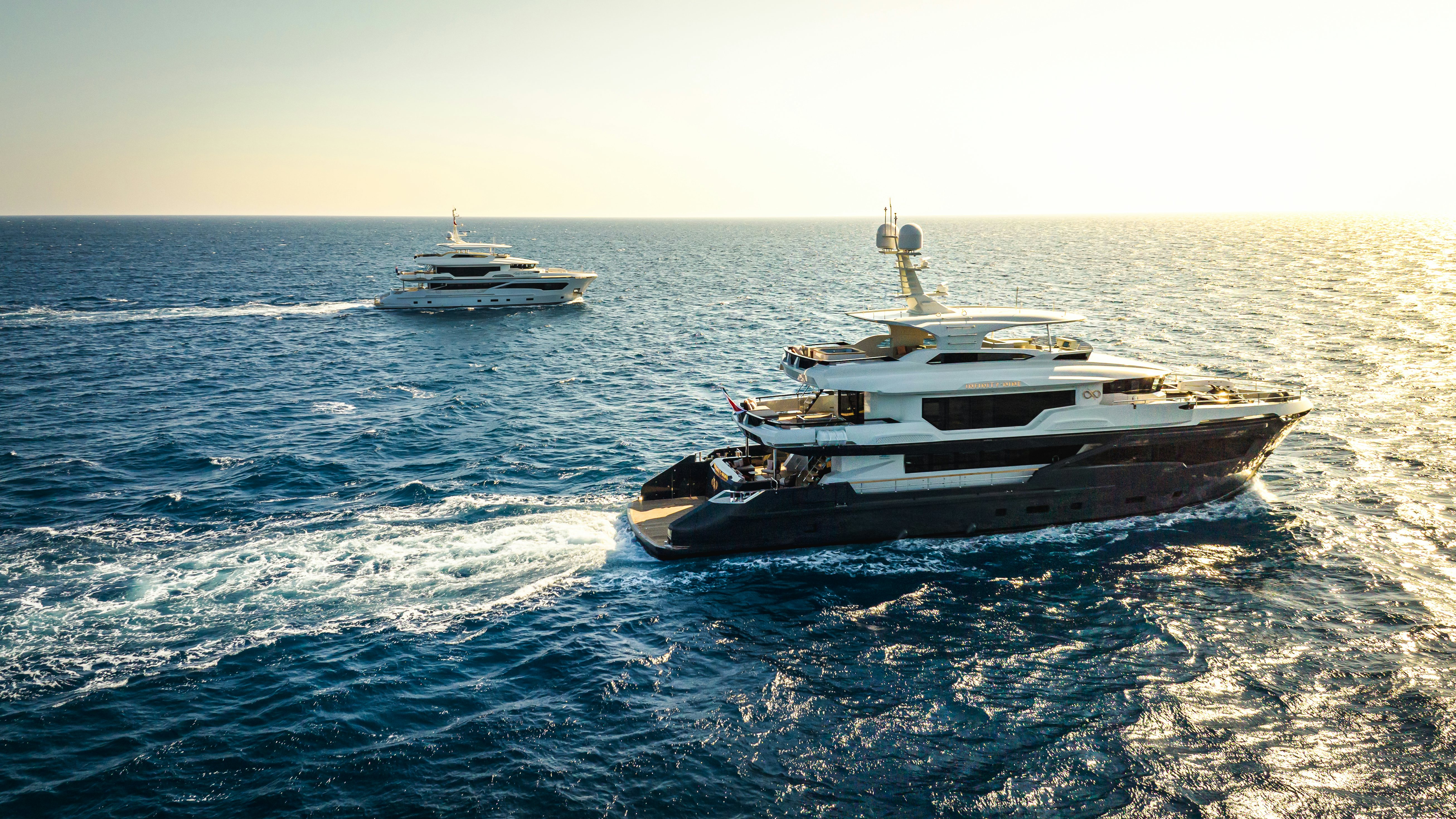 a couple of boats in the water aboard KANDO 110 Yacht for Sale