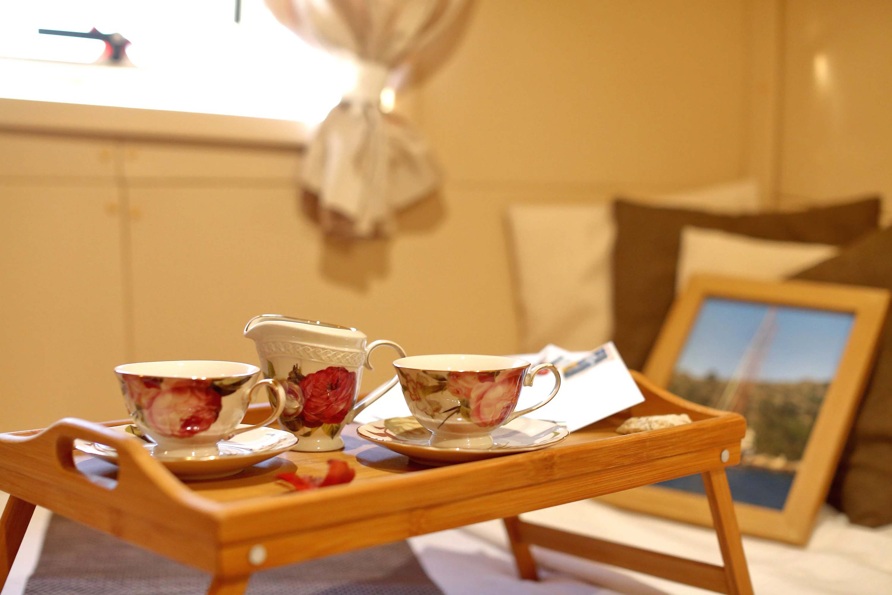 a table with tea cups and a laptop on it aboard GULET GARDELIN Yacht for Charter