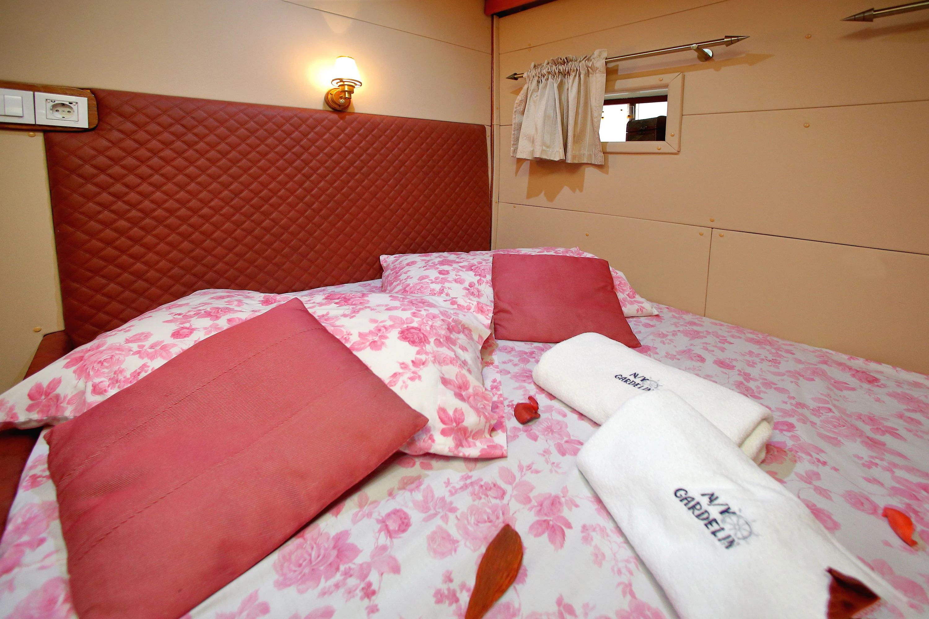 a bed with pink pillows aboard GULET GARDELIN Yacht for Charter