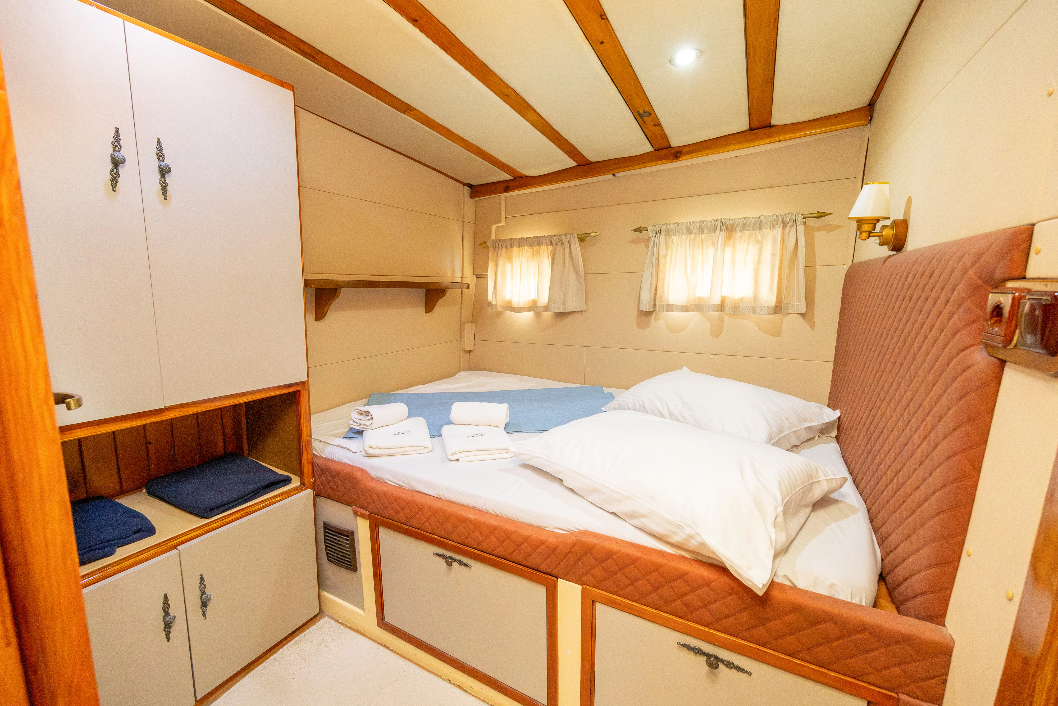 a room with a bed and cabinets aboard GULET GARDELIN Yacht for Charter