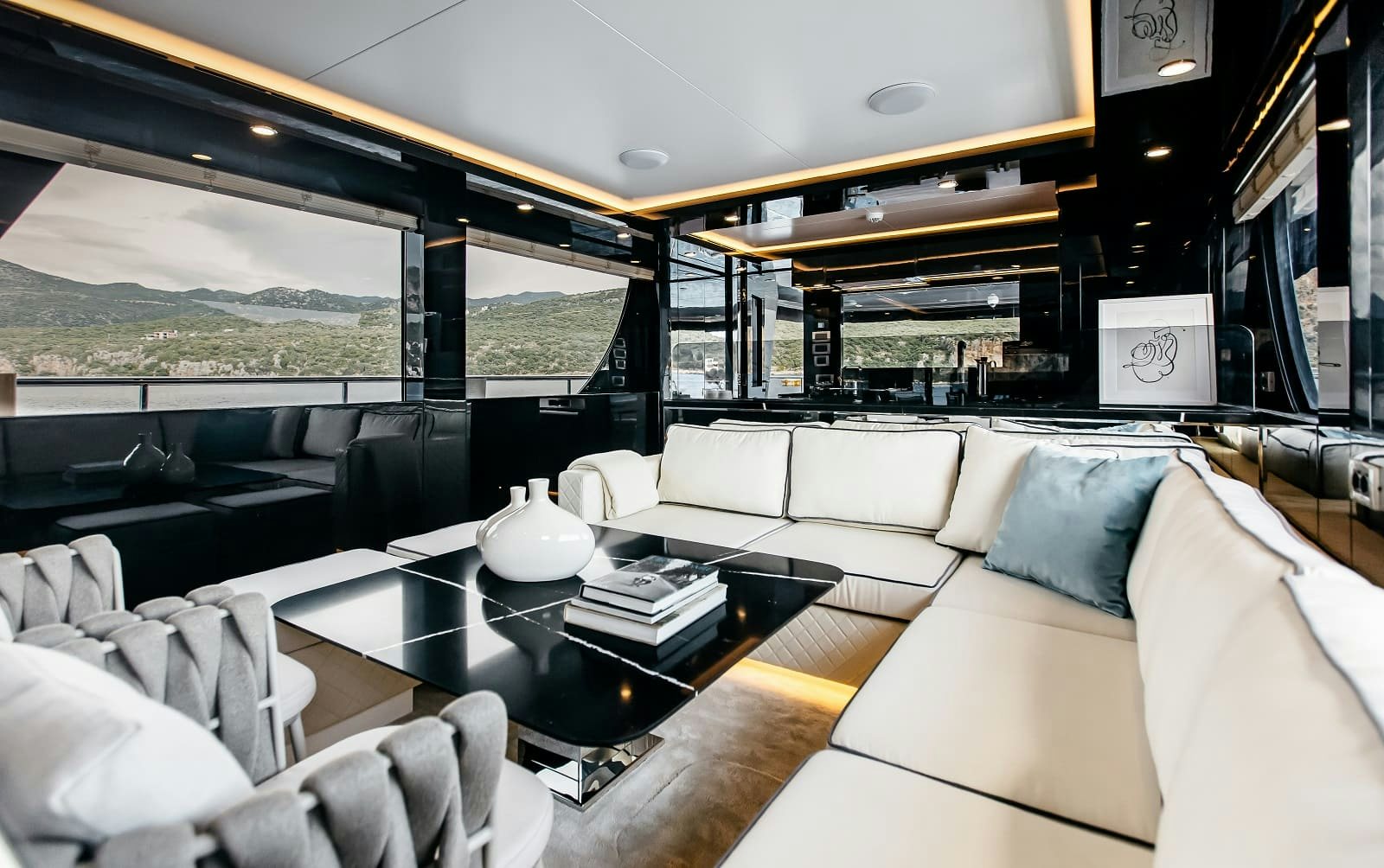 a living room with a large screen aboard LEVANNA Yacht for Sale