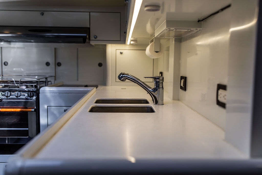 a kitchen with a sink and stove aboard CABOCHON Yacht for Sale
