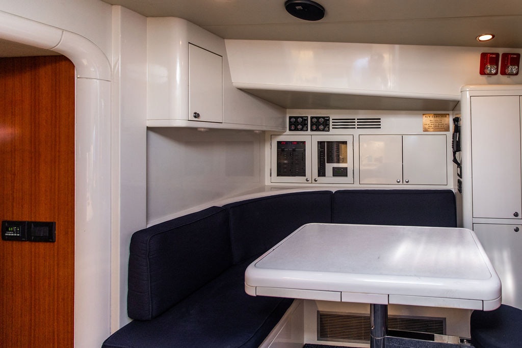 a room with a table and a couch aboard CABOCHON Yacht for Sale