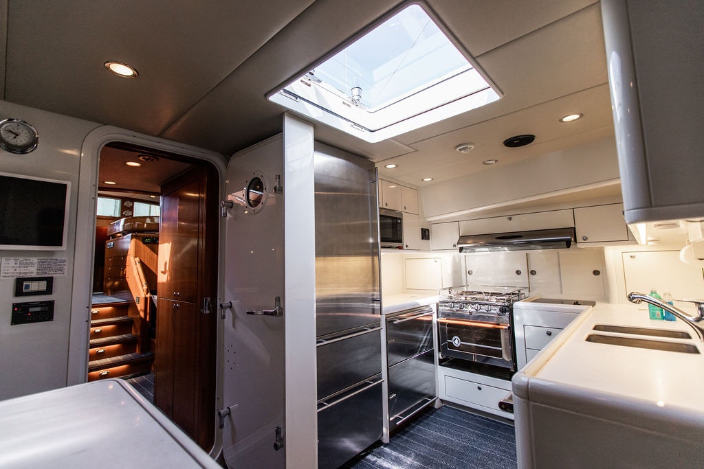 a kitchen with a glass door aboard CABOCHON Yacht for Sale