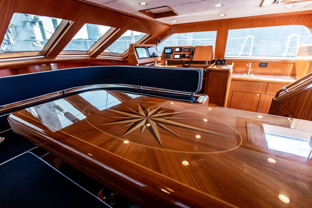a large wooden boat in a building aboard CABOCHON Yacht for Sale