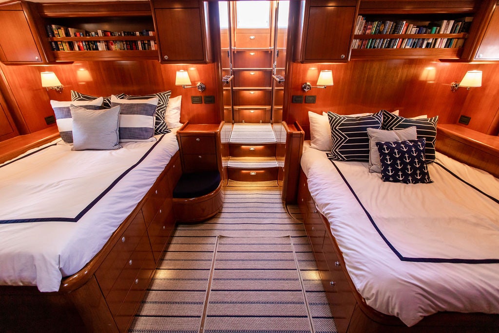 a room with a couple beds aboard CABOCHON Yacht for Sale