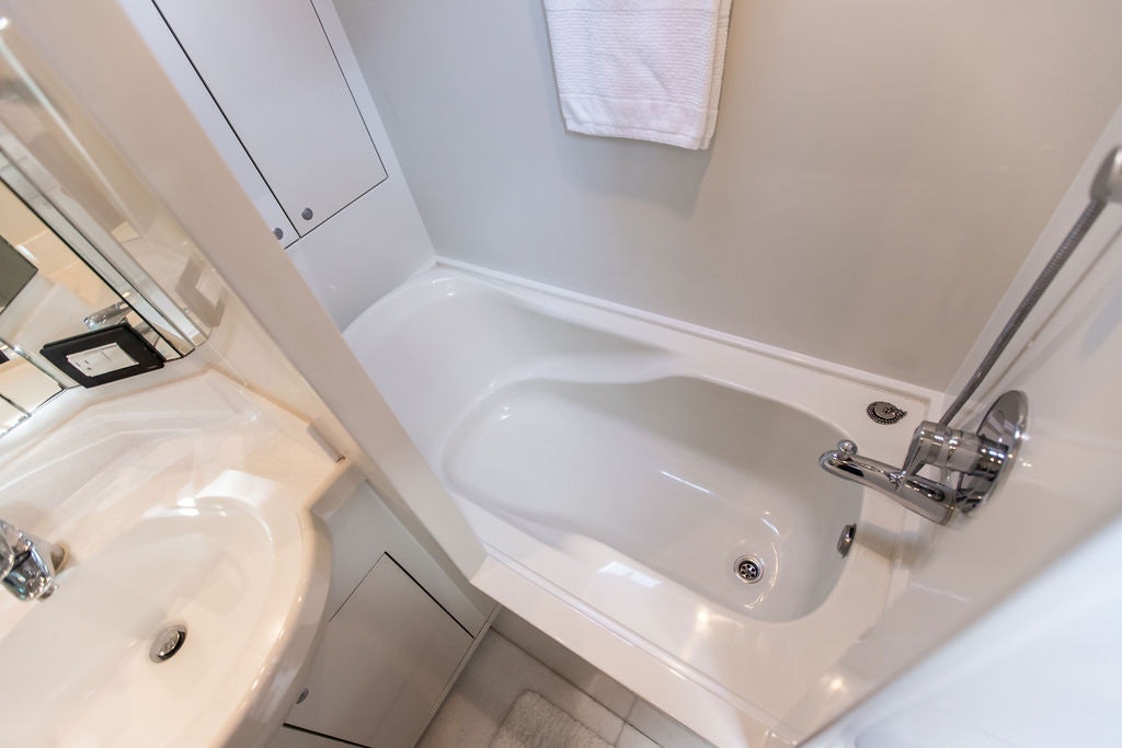 a bathroom with a sink and a mirror aboard CABOCHON Yacht for Sale