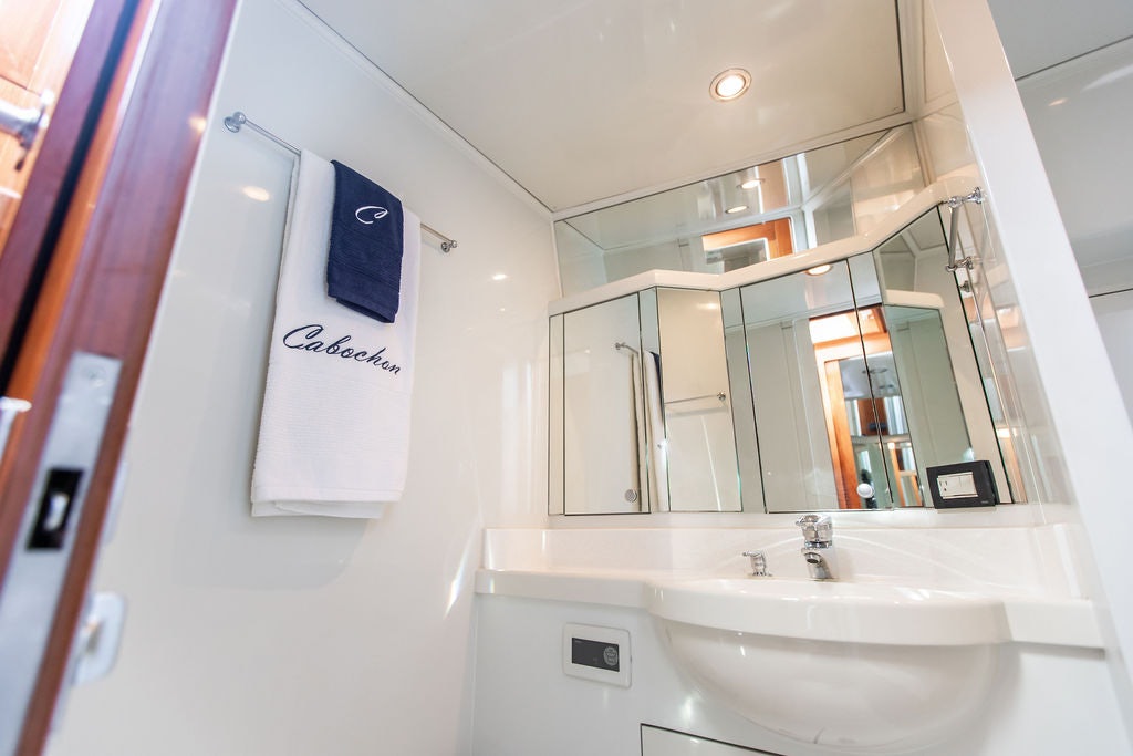 a bathroom with a sink and a mirror aboard CABOCHON Yacht for Sale