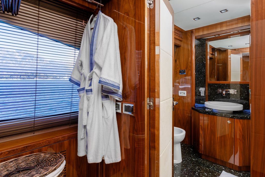 a bathroom with a robe on the wall aboard KATARIINA I Yacht for Charter