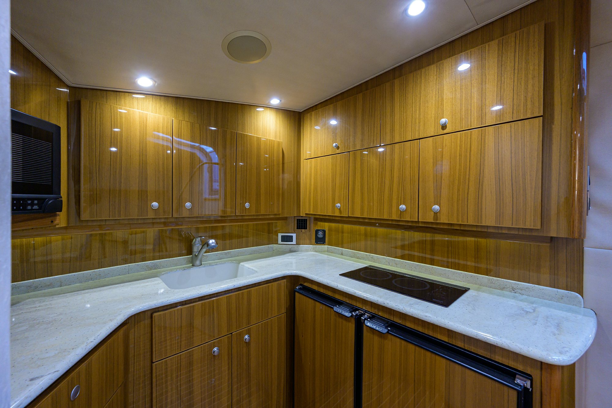 a kitchen with wooden cabinets aboard GALENE Yacht for Sale
