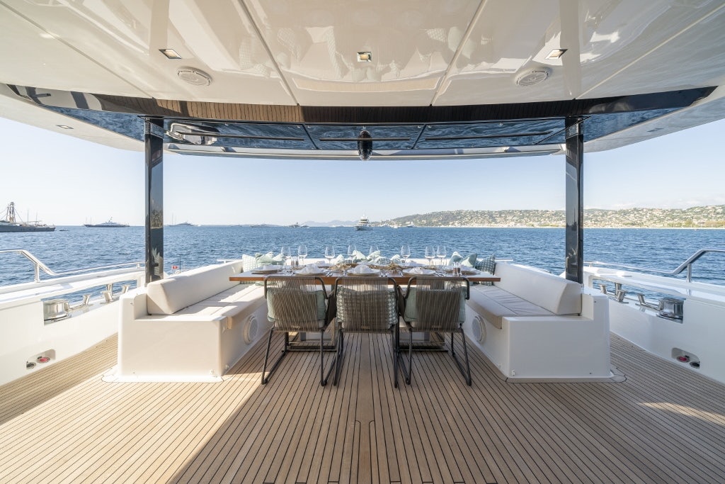 a table and chairs on a deck aboard ELYSIUM I Yacht for Sale