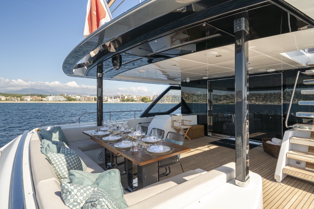 a table and chairs on a deck aboard ELYSIUM I Yacht for Sale