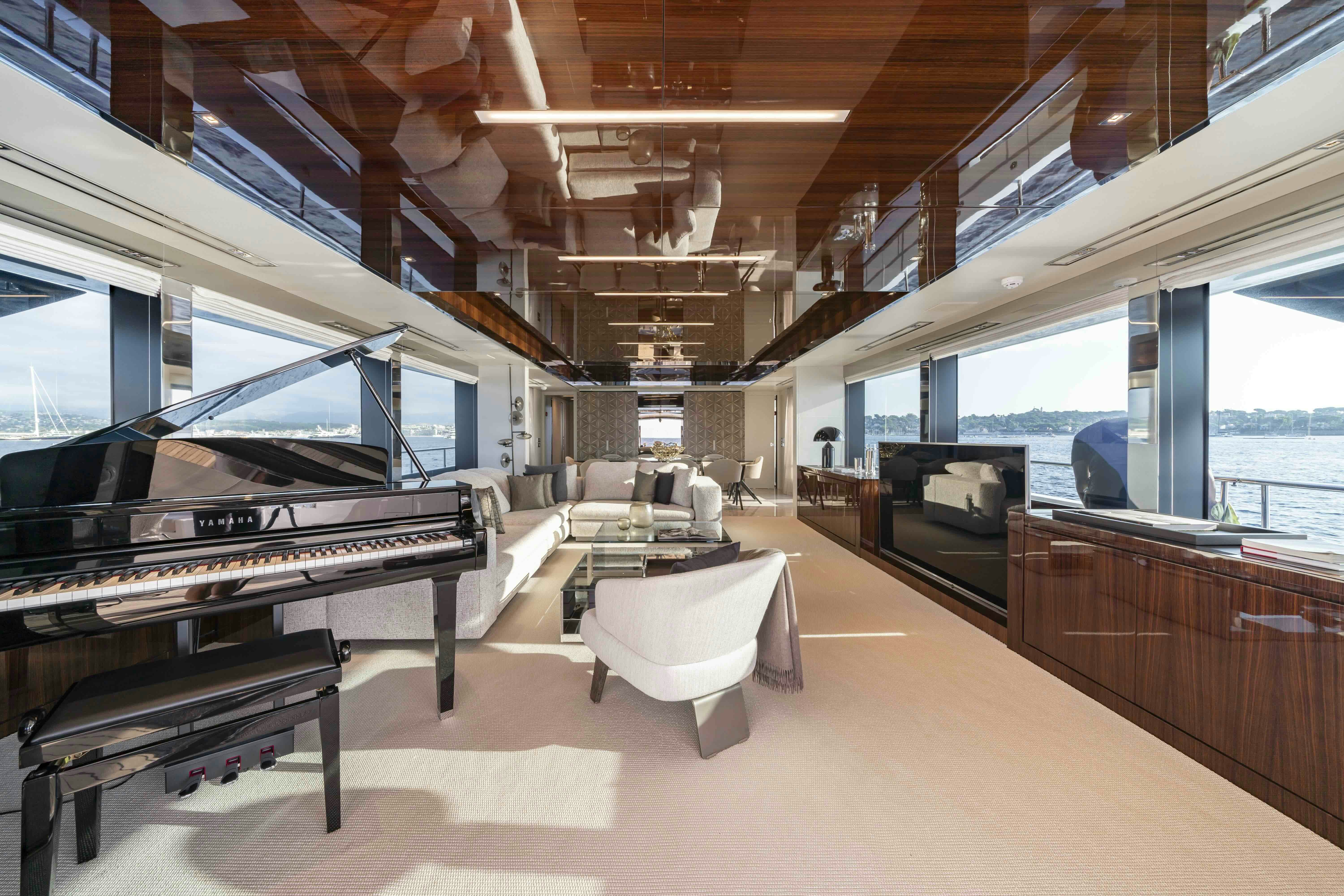 a room with a piano and a couch aboard ELYSIUM I Yacht for Sale