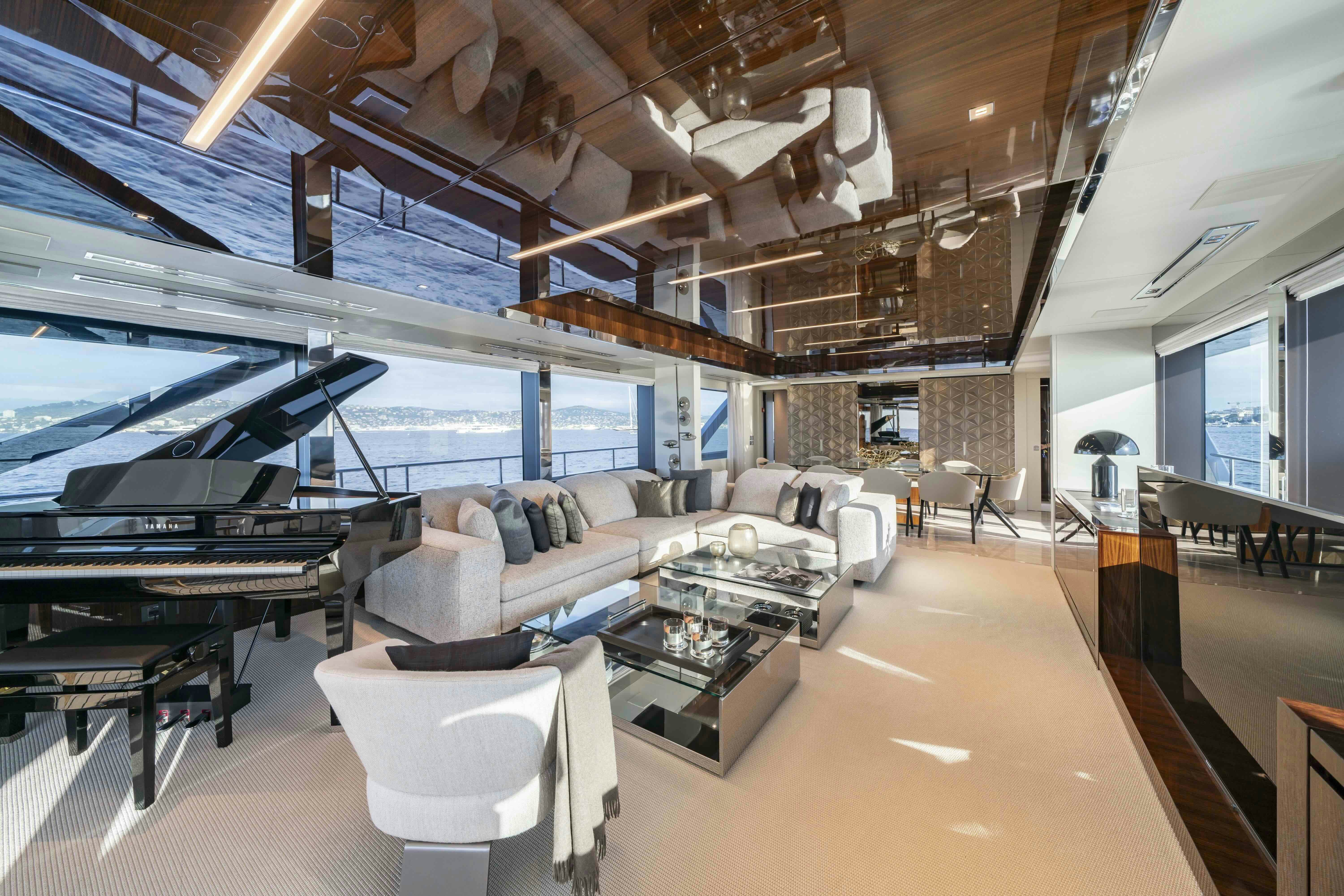 a large living room with a piano aboard ELYSIUM I Yacht for Sale