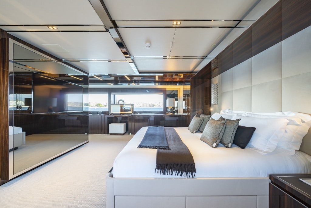 a room with a bed and a couch aboard ELYSIUM I Yacht for Sale