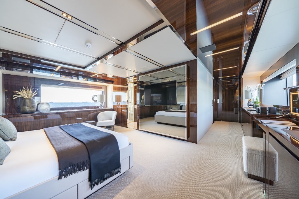 a modern bedroom with a large open layout aboard ELYSIUM I Yacht for Sale
