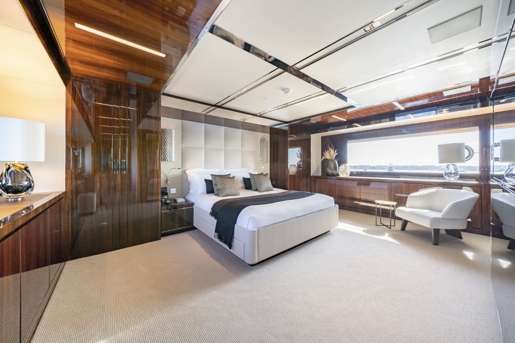 a large bedroom with a large bed aboard ELYSIUM I Yacht for Sale