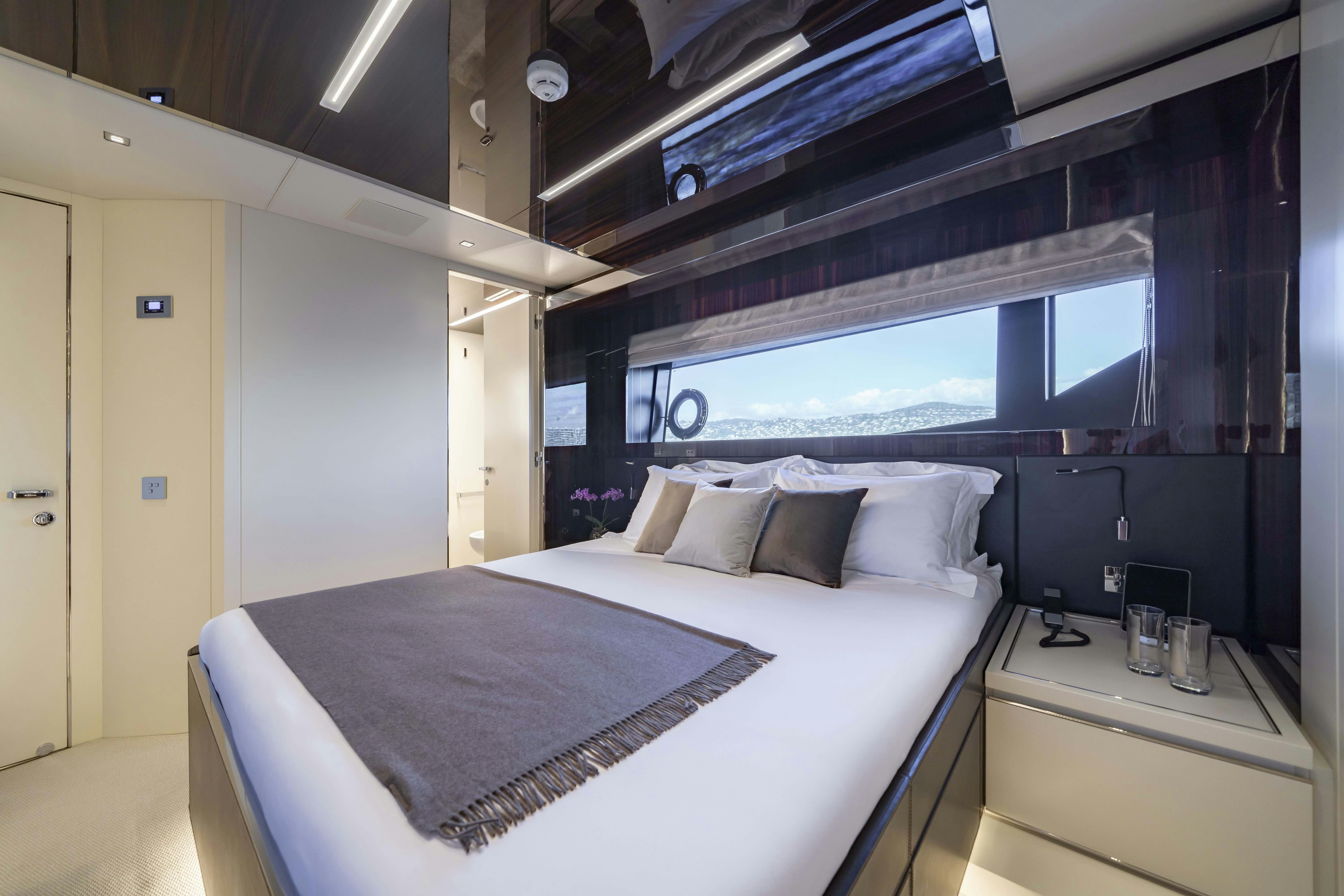 a room with a bed and a tv aboard ELYSIUM I Yacht for Sale