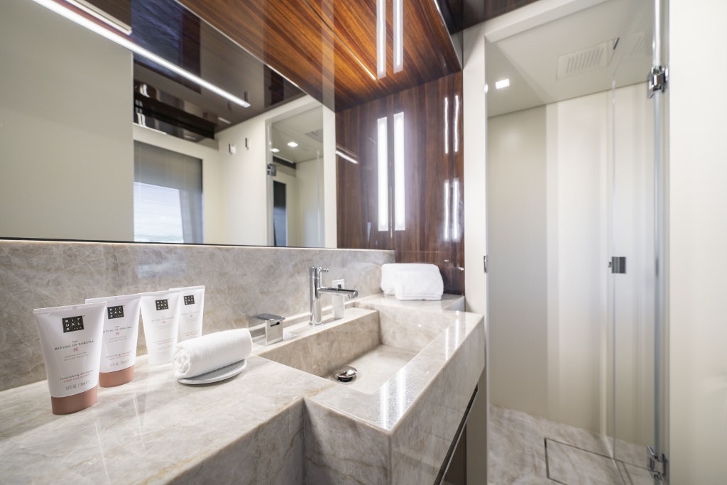 a bathroom with a countertop sink and mirror aboard ELYSIUM I Yacht for Sale