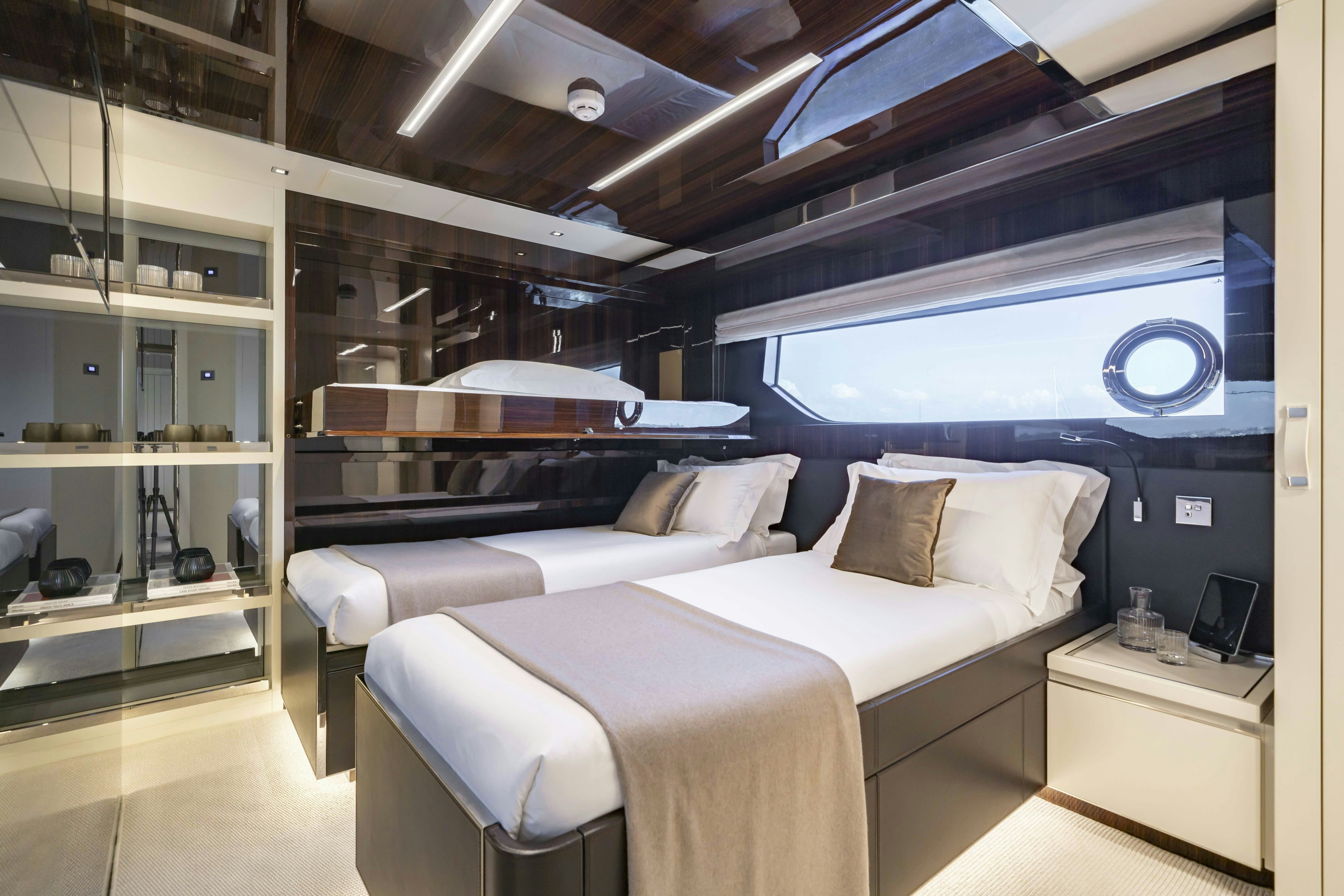 a room with a bed and a large window aboard ELYSIUM I Yacht for Sale