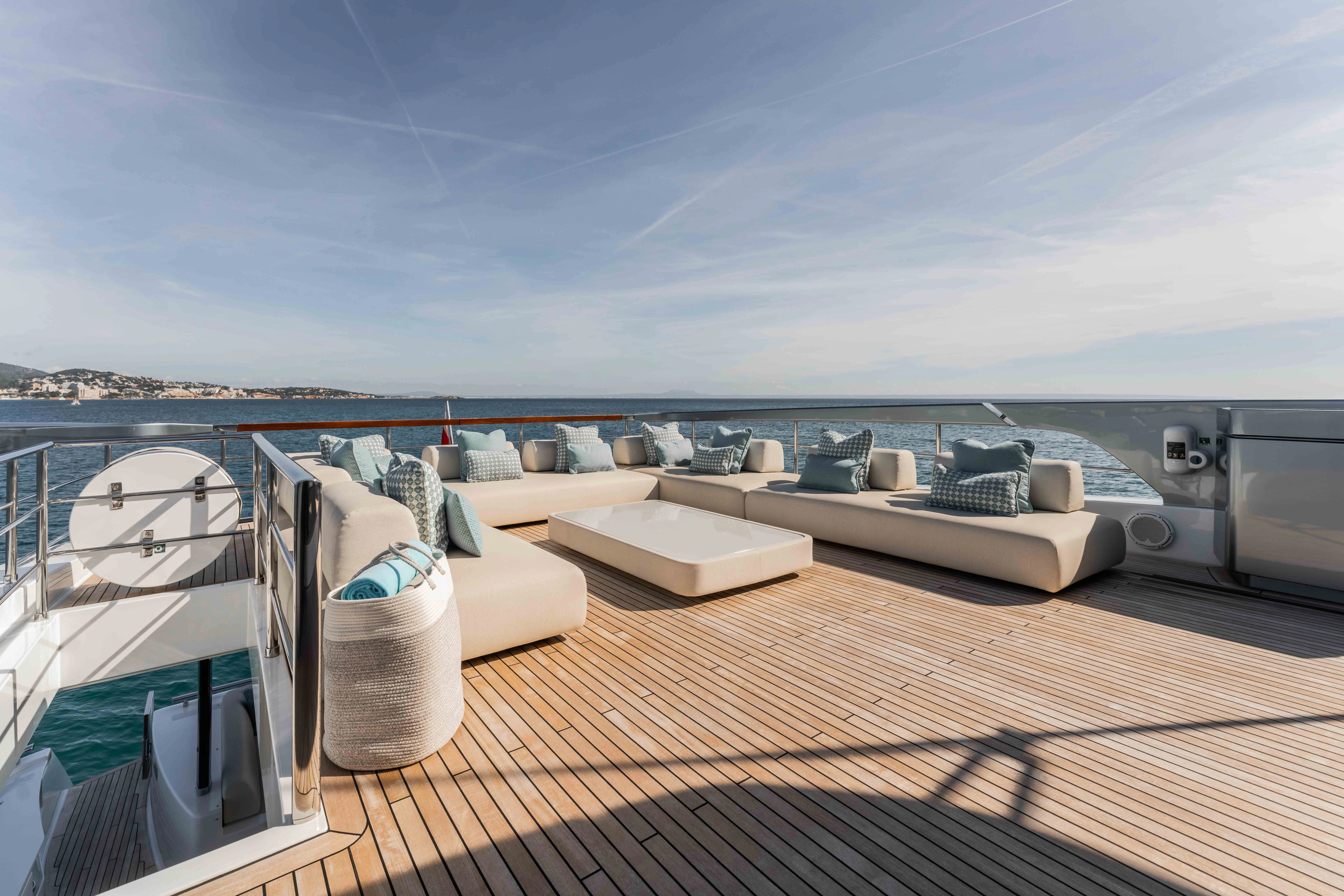 a deck with a large bed and a large body of water aboard ELYSIUM I Yacht for Sale