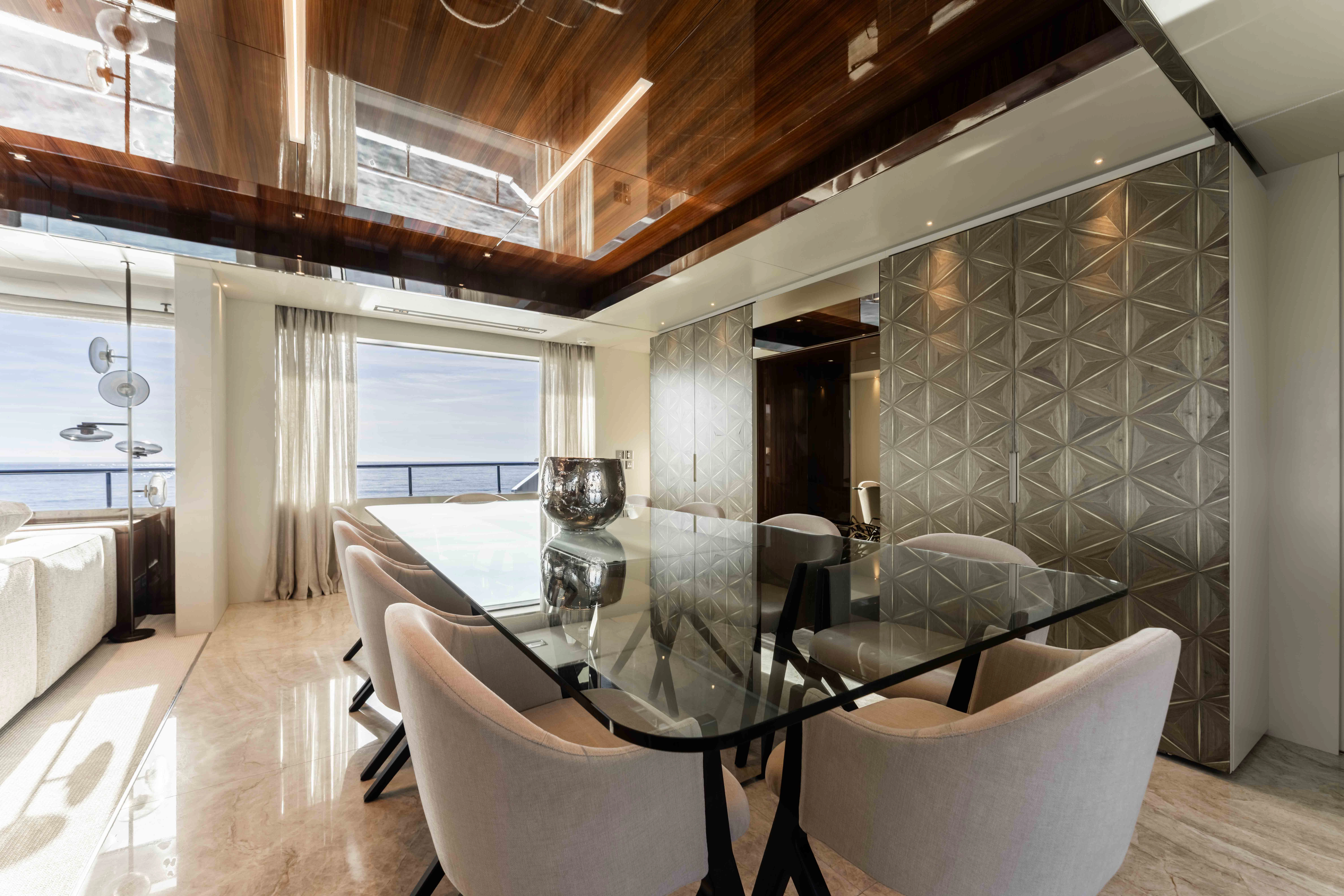 a room with a table chairs and a large window aboard ELYSIUM I Yacht for Sale