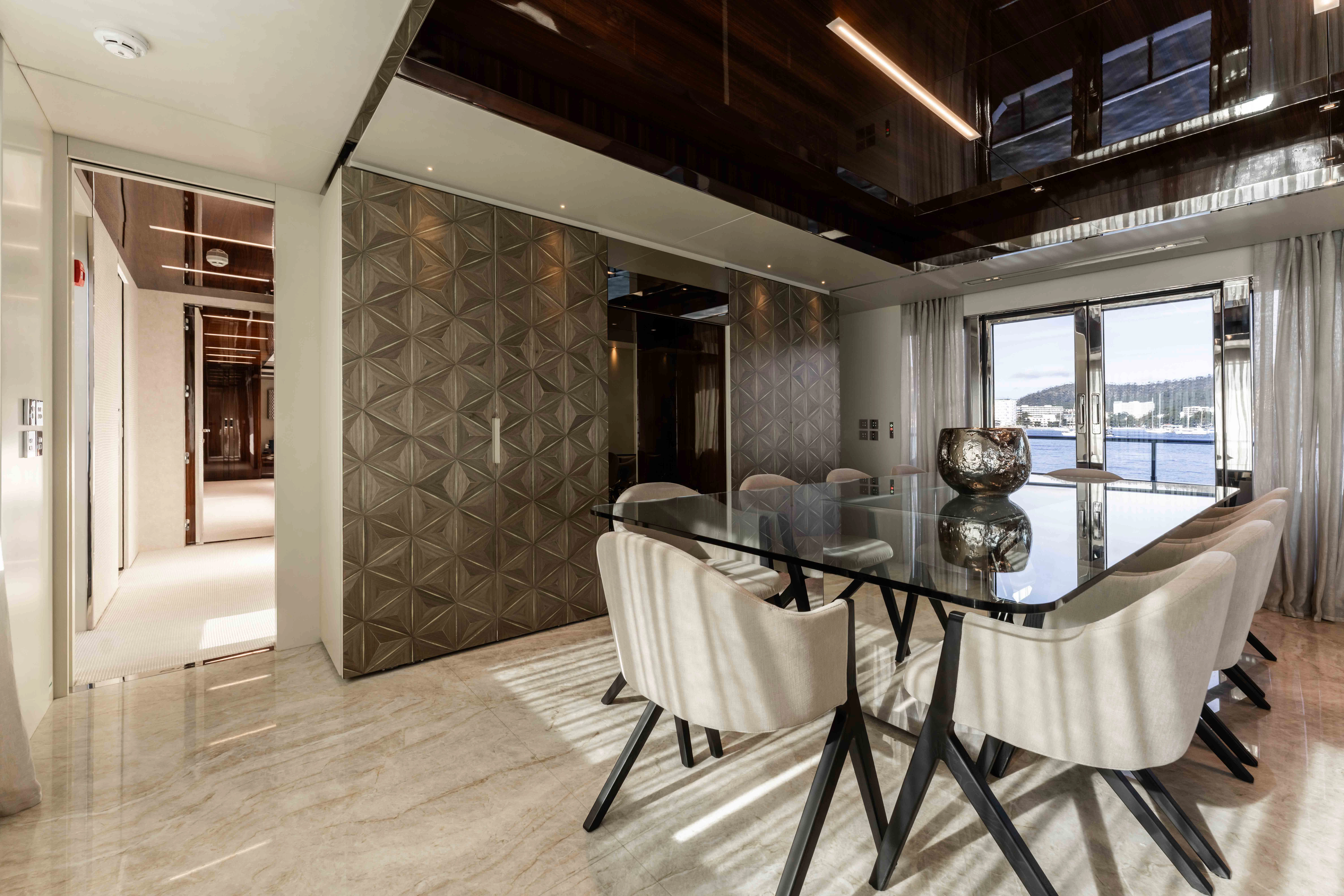 a large room with a table and chairs aboard ELYSIUM I Yacht for Sale