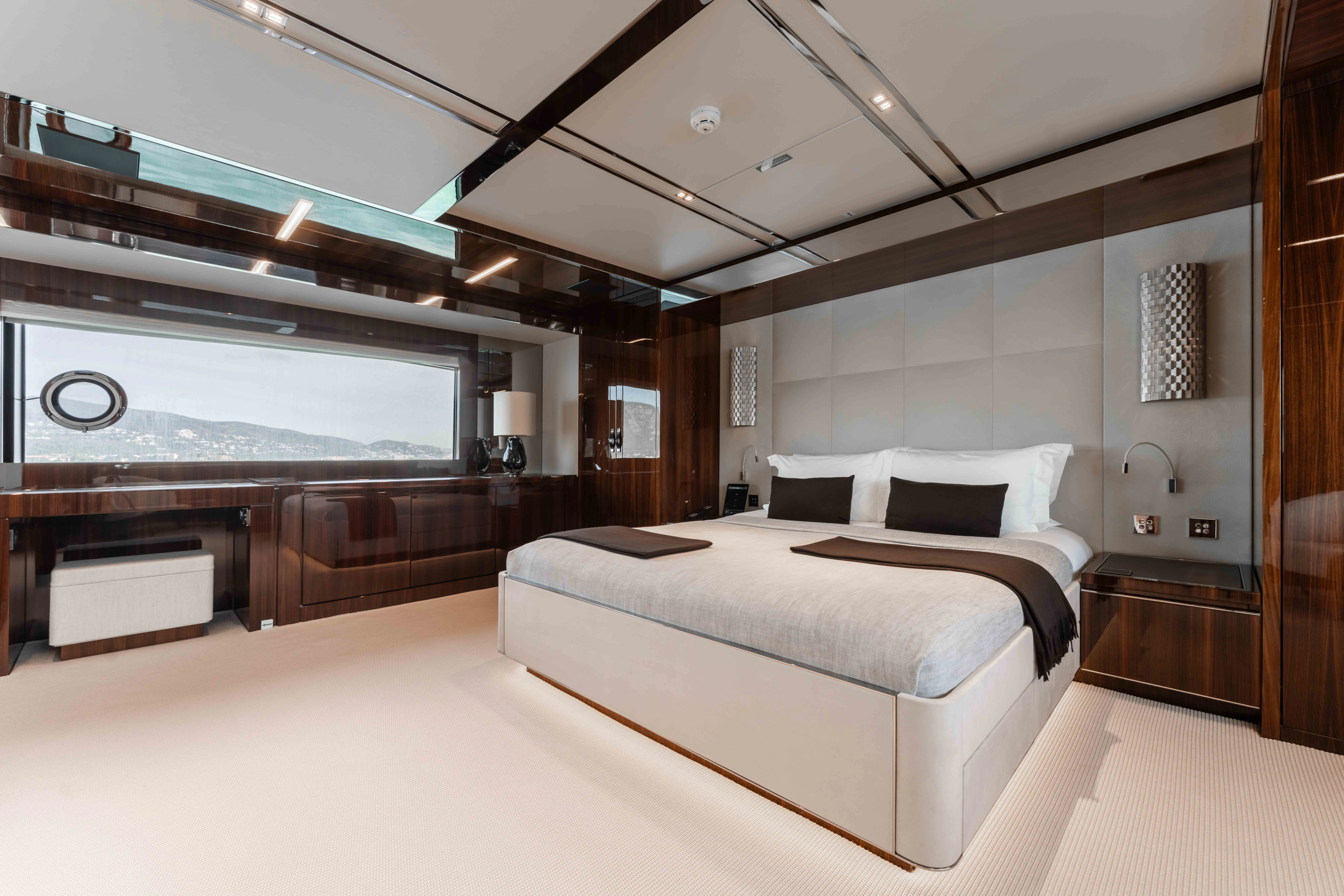 a large room with a bed and a large window aboard ELYSIUM I Yacht for Sale