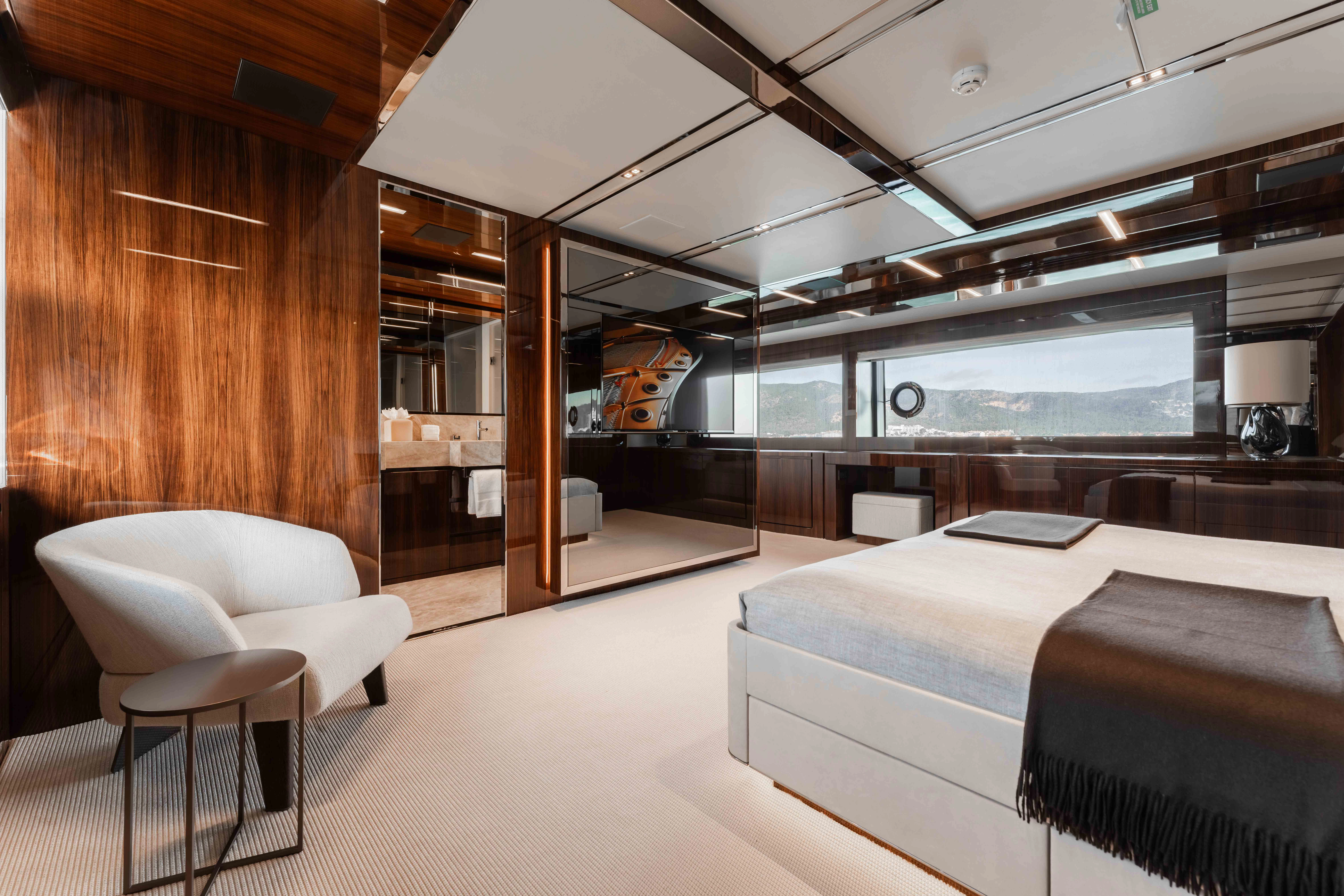 a room with a bed and a desk aboard ELYSIUM I Yacht for Sale
