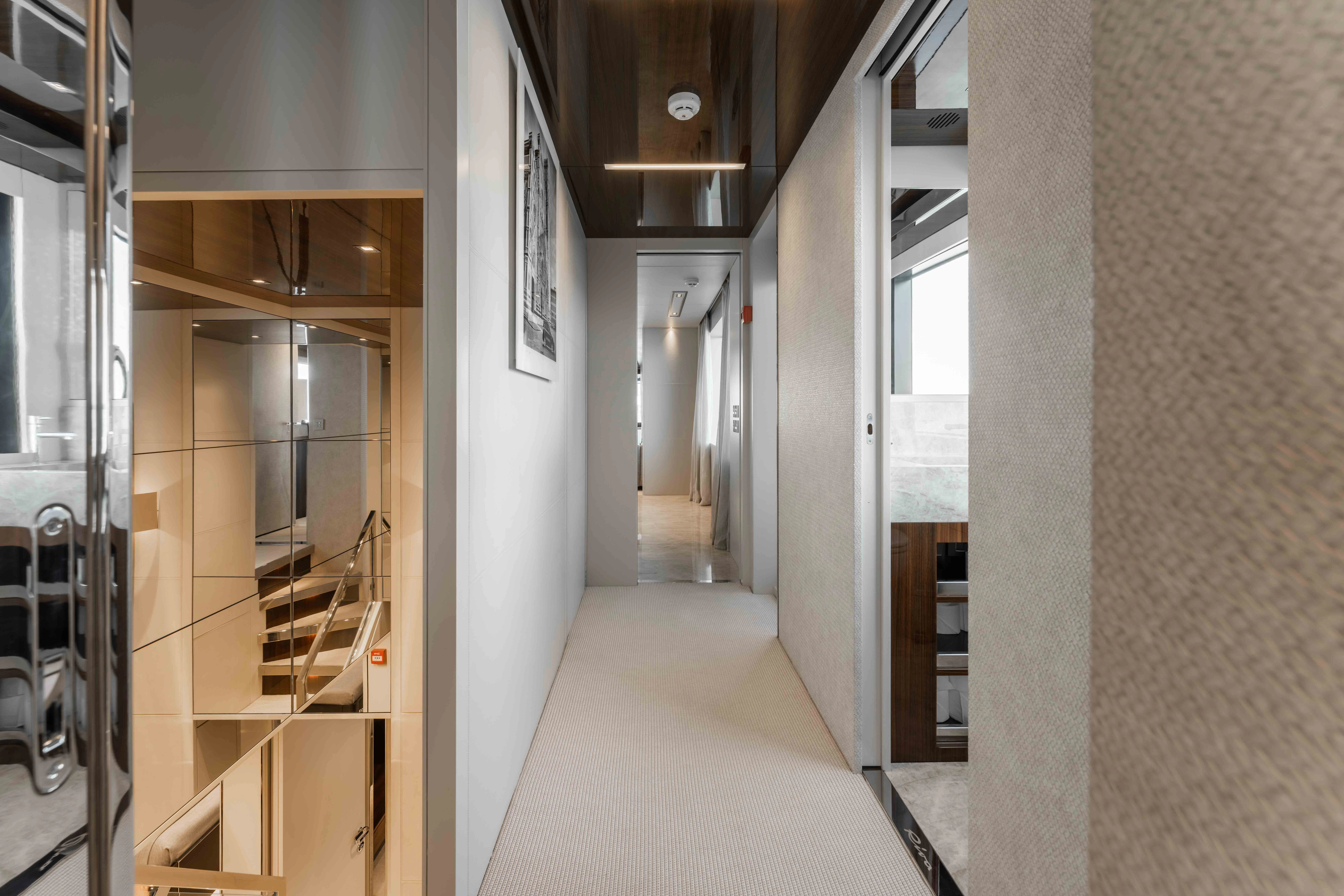 a hallway with a staircase and a glass door aboard ELYSIUM I Yacht for Sale