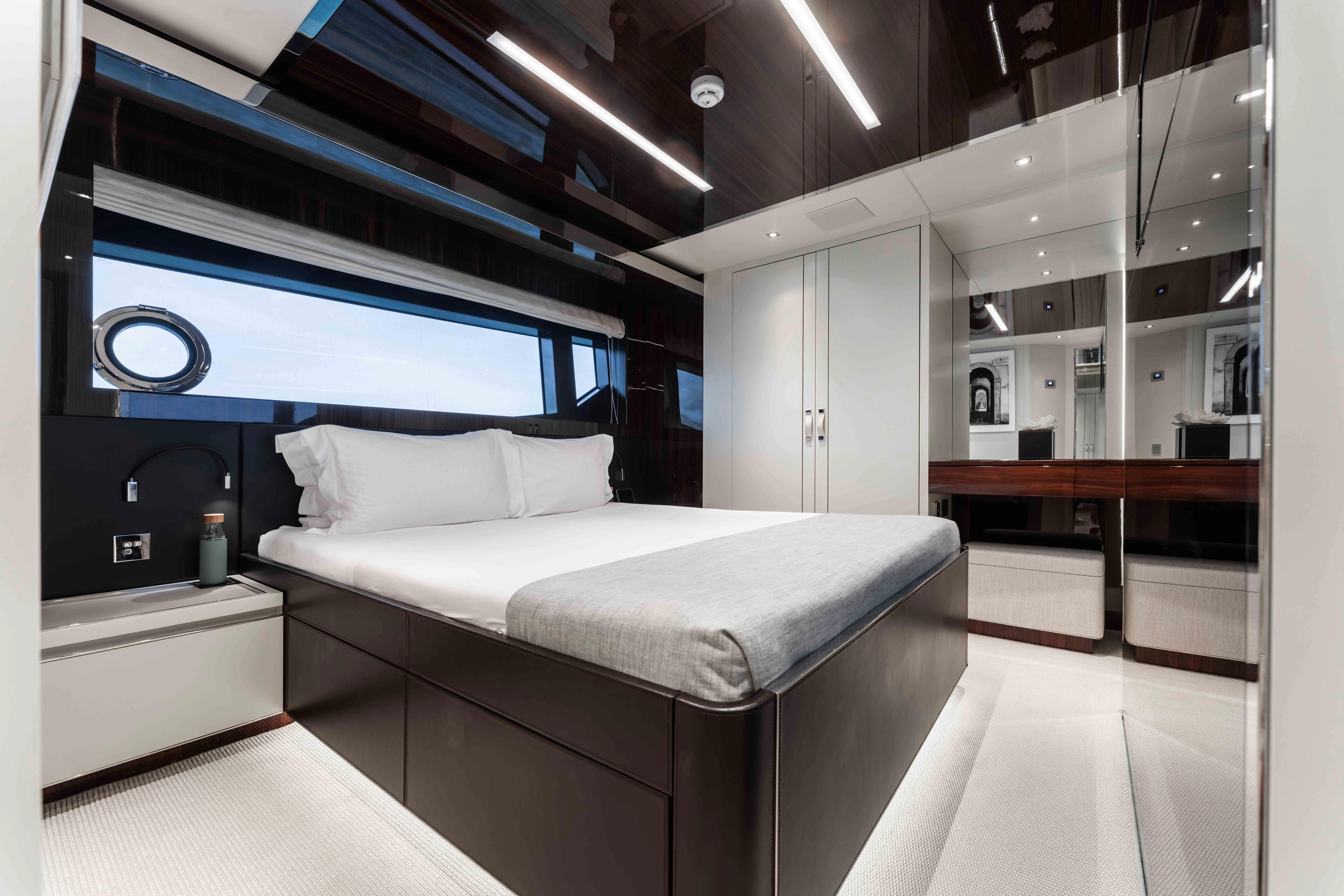 a room with a bed and a large screen aboard ELYSIUM I Yacht for Sale