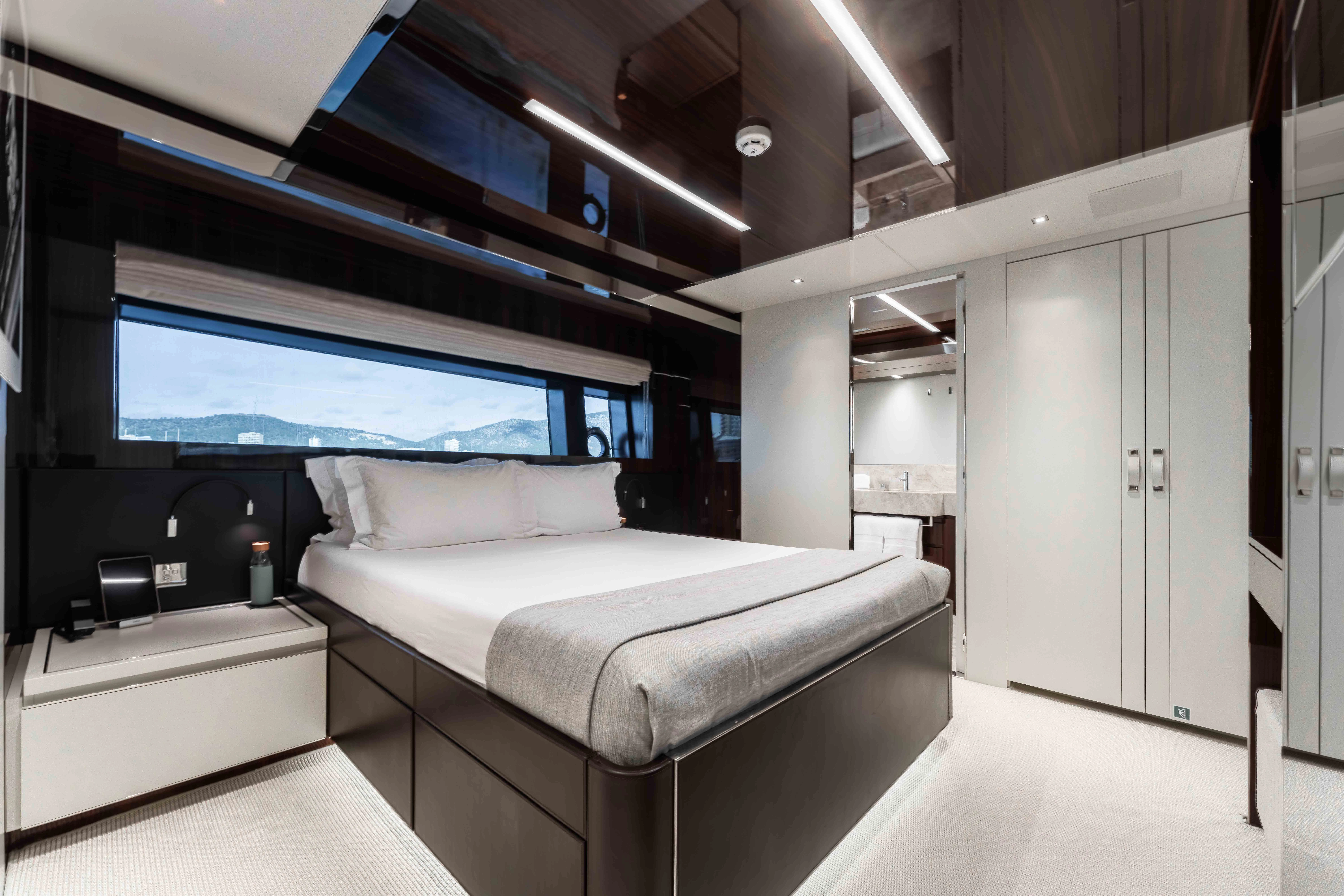 a room with a bed and a tv aboard ELYSIUM I Yacht for Sale
