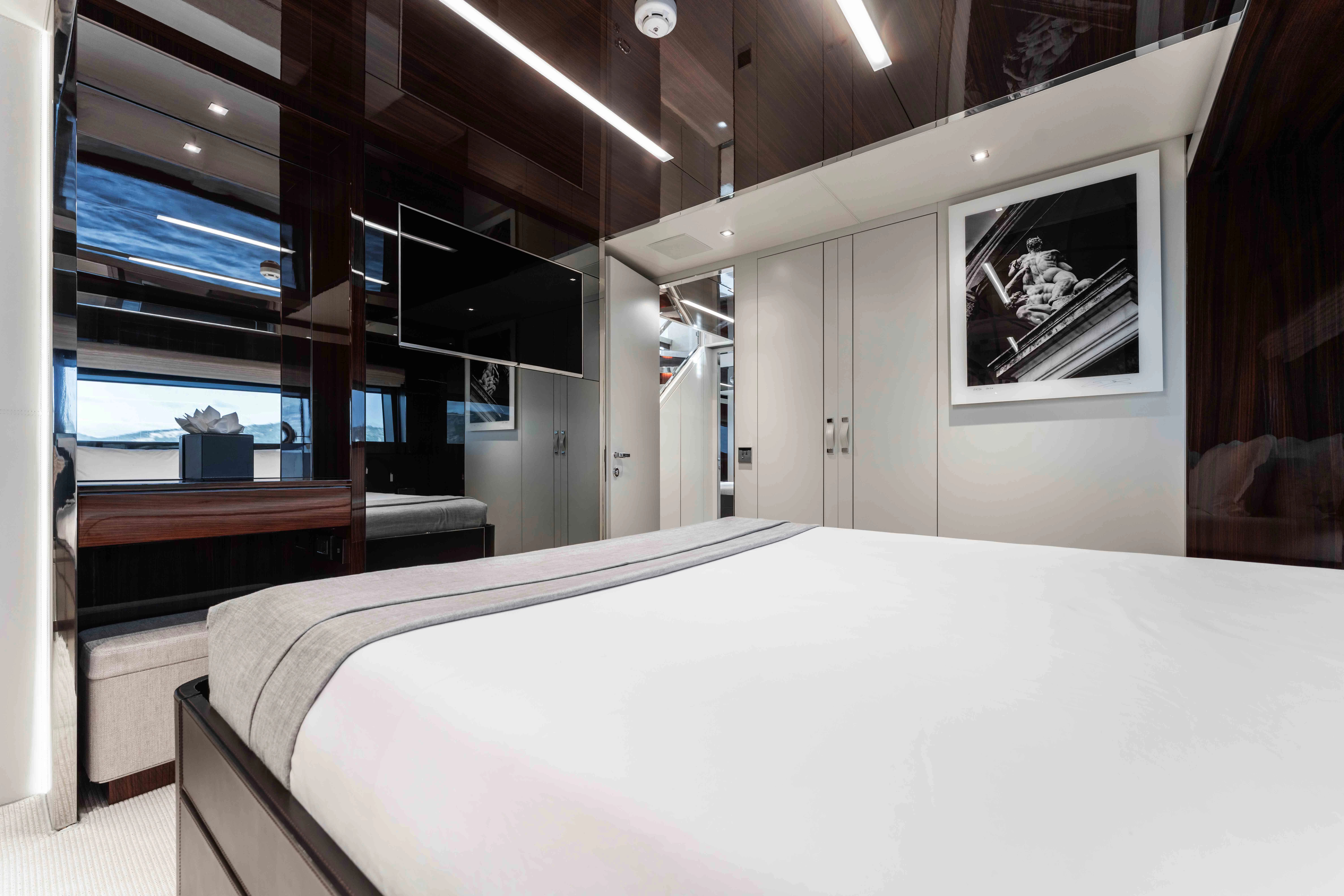 a room with a bed and a window aboard ELYSIUM I Yacht for Sale