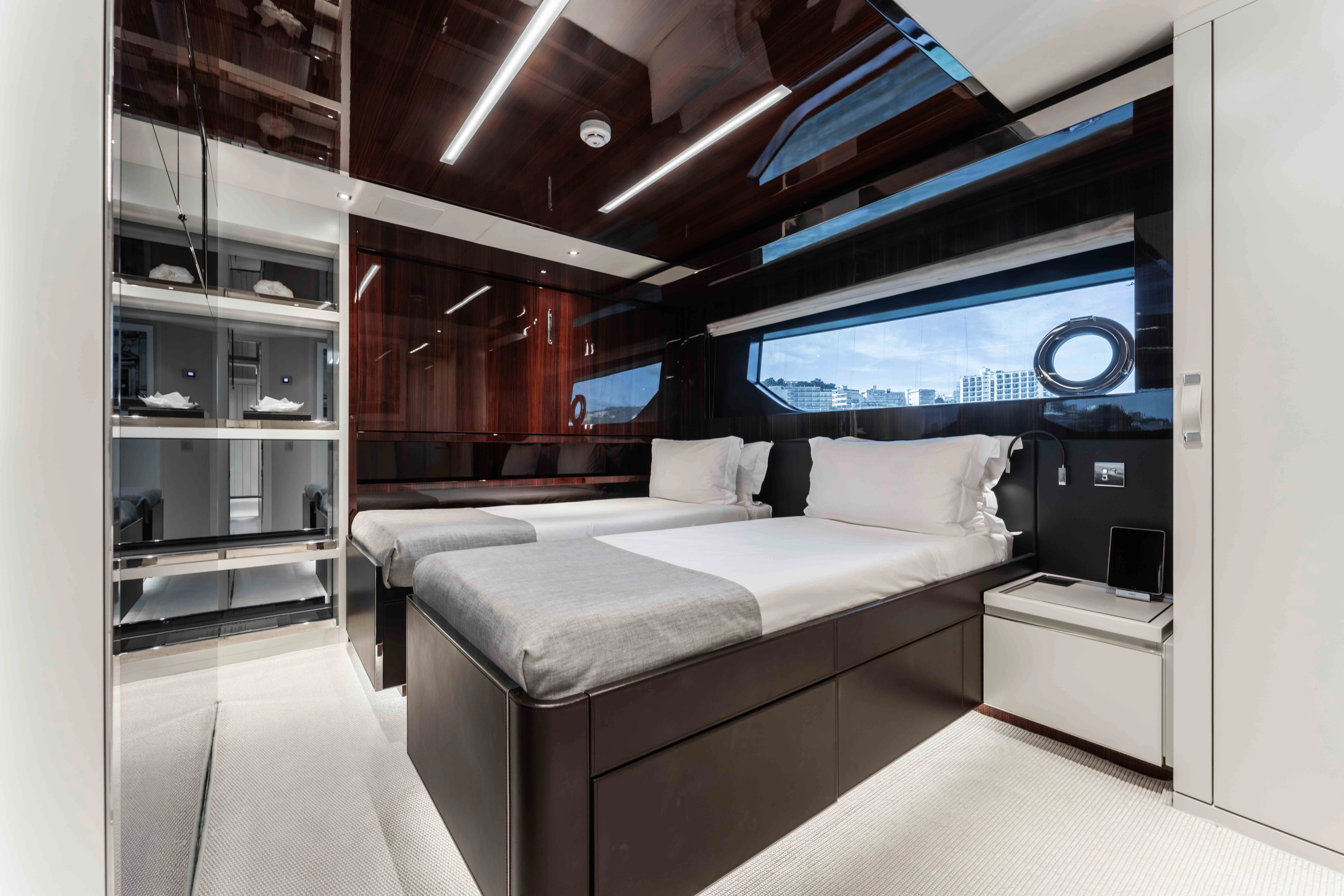 a room with a bed and a tv aboard ELYSIUM I Yacht for Sale