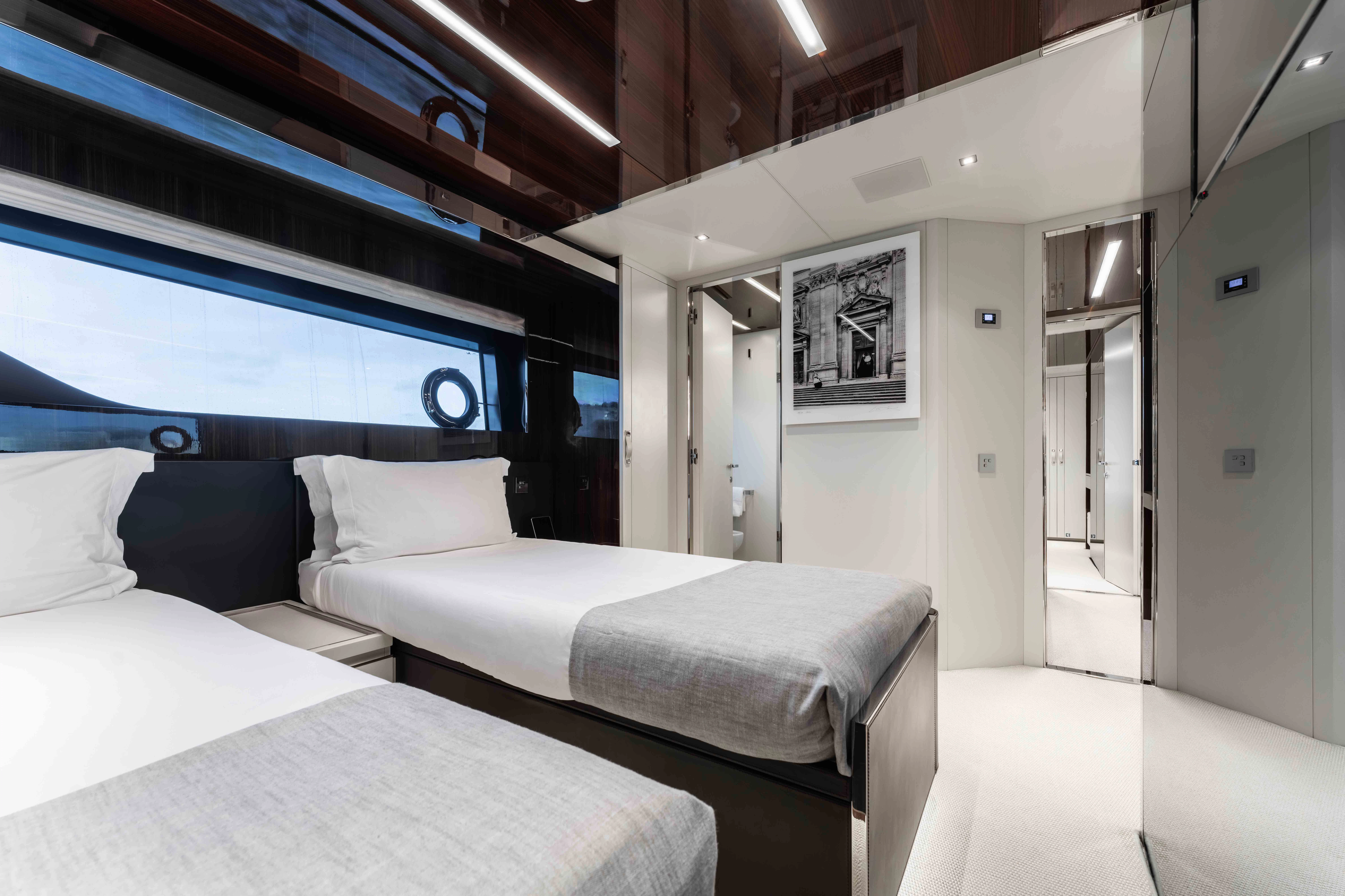 a room with beds and a window aboard ELYSIUM I Yacht for Sale
