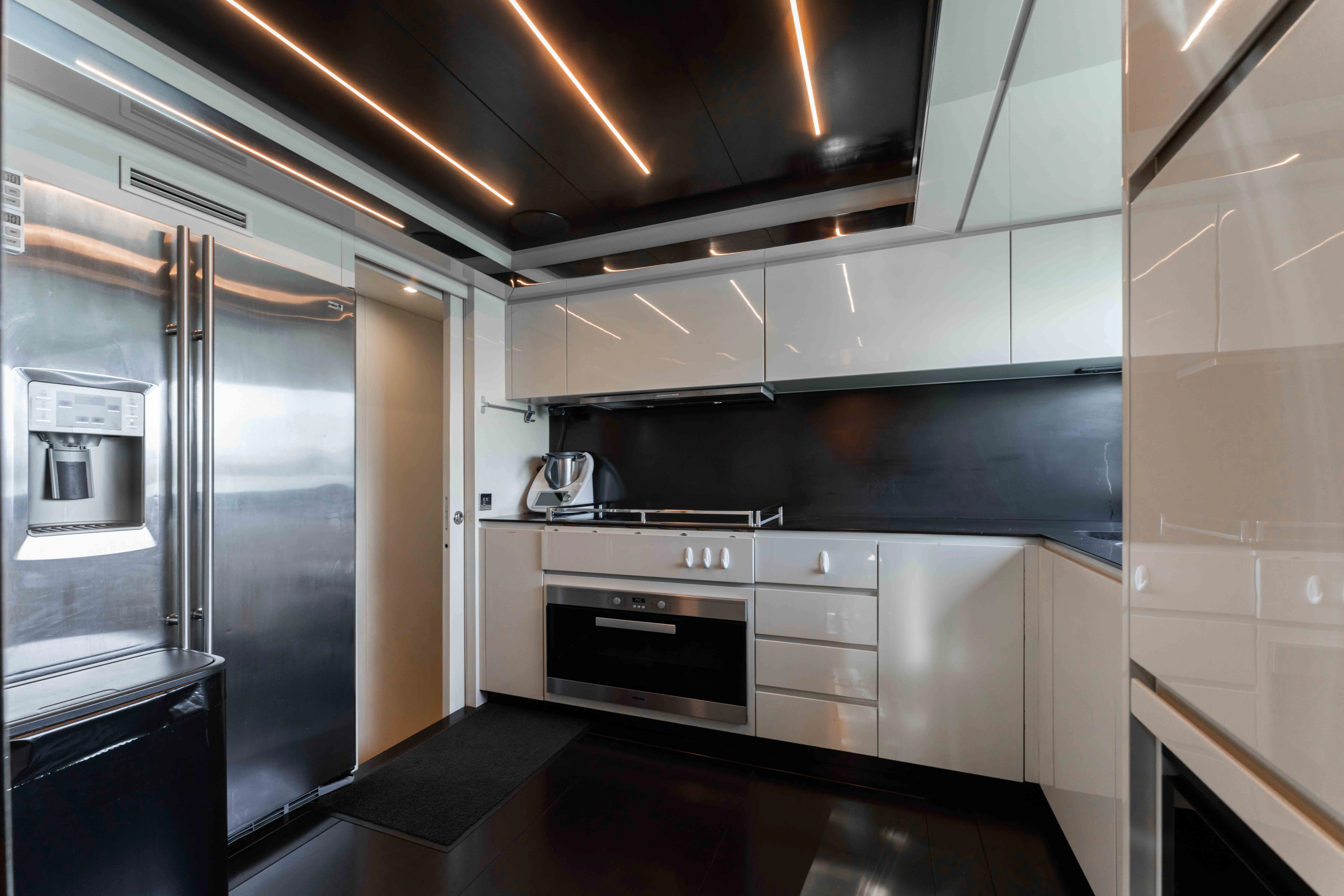 a kitchen with a stainless steel refrigerator aboard ELYSIUM I Yacht for Sale
