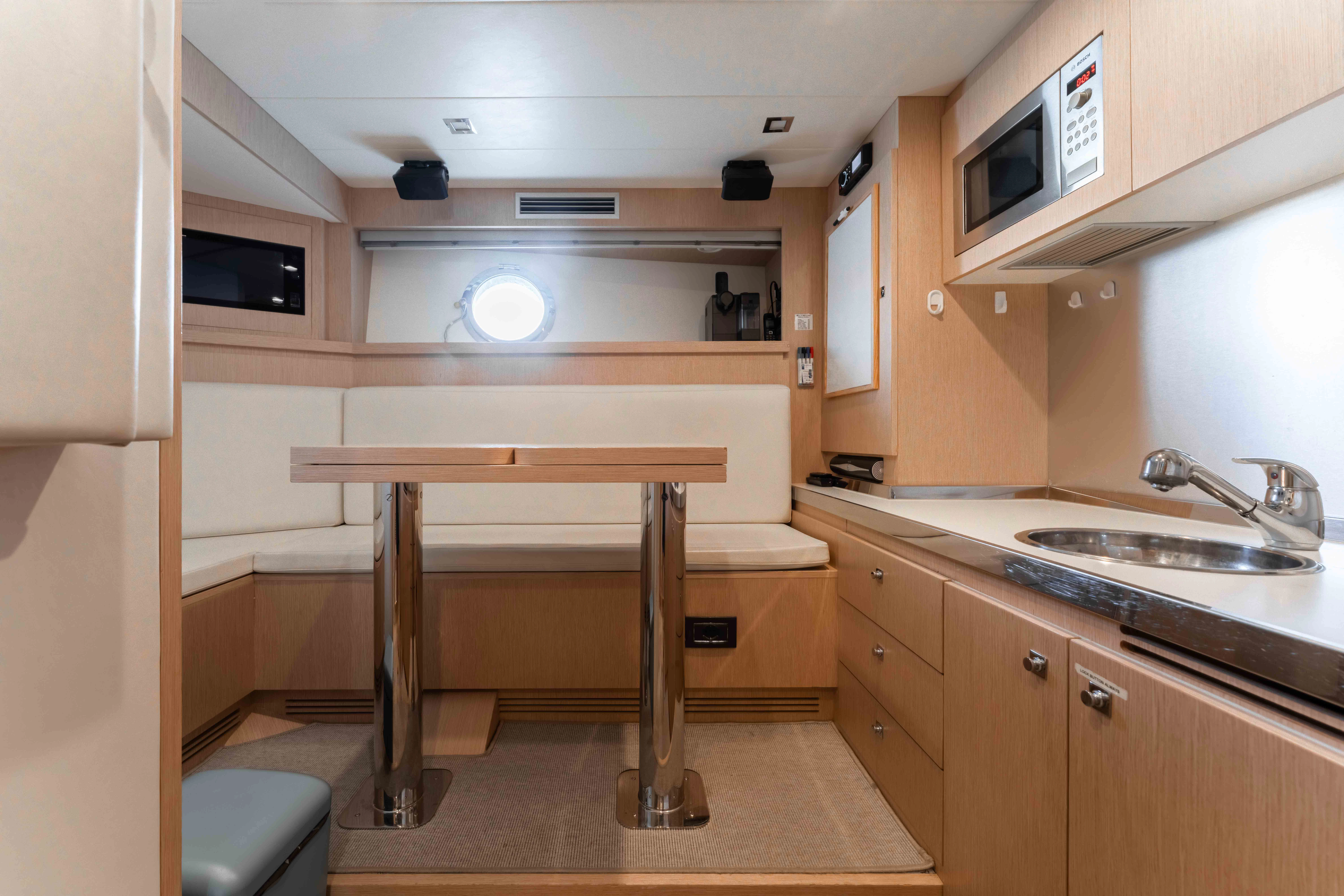a small kitchen with a table aboard ELYSIUM I Yacht for Sale