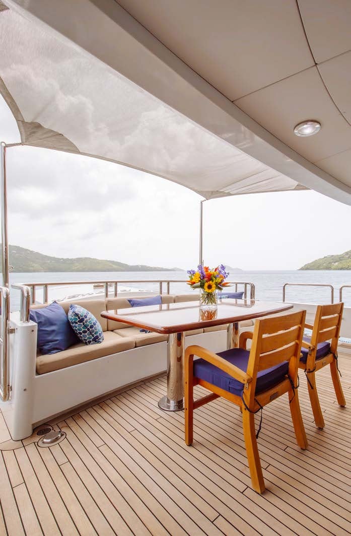 a table and chairs on a deck aboard JUST ENOUGH Yacht for Charter