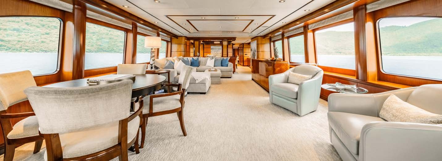 a large living room with a large window aboard JUST ENOUGH Yacht for Charter