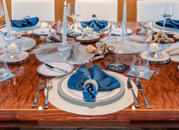 a table with a plate of food and silverware aboard JUST ENOUGH Yacht for Charter