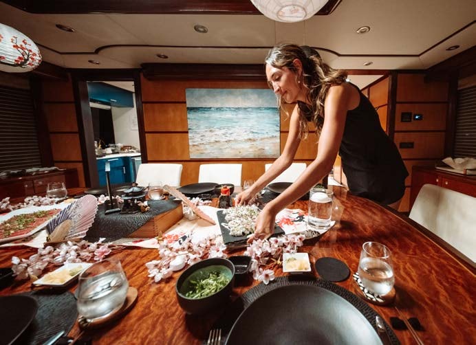 a person preparing food in a kitchen aboard JUST ENOUGH Yacht for Charter