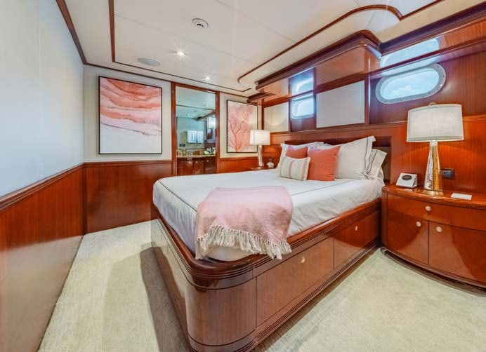 a hotel room with a bed and a desk aboard JUST ENOUGH Yacht for Charter