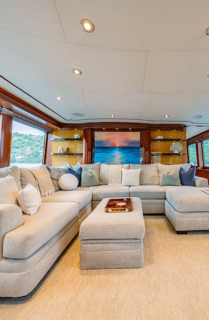 a living room with a couch and a table aboard JUST ENOUGH Yacht for Charter