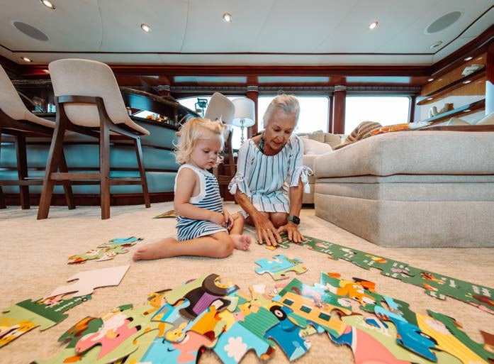 a person and a little girl playing with a toy aboard JUST ENOUGH Yacht for Charter
