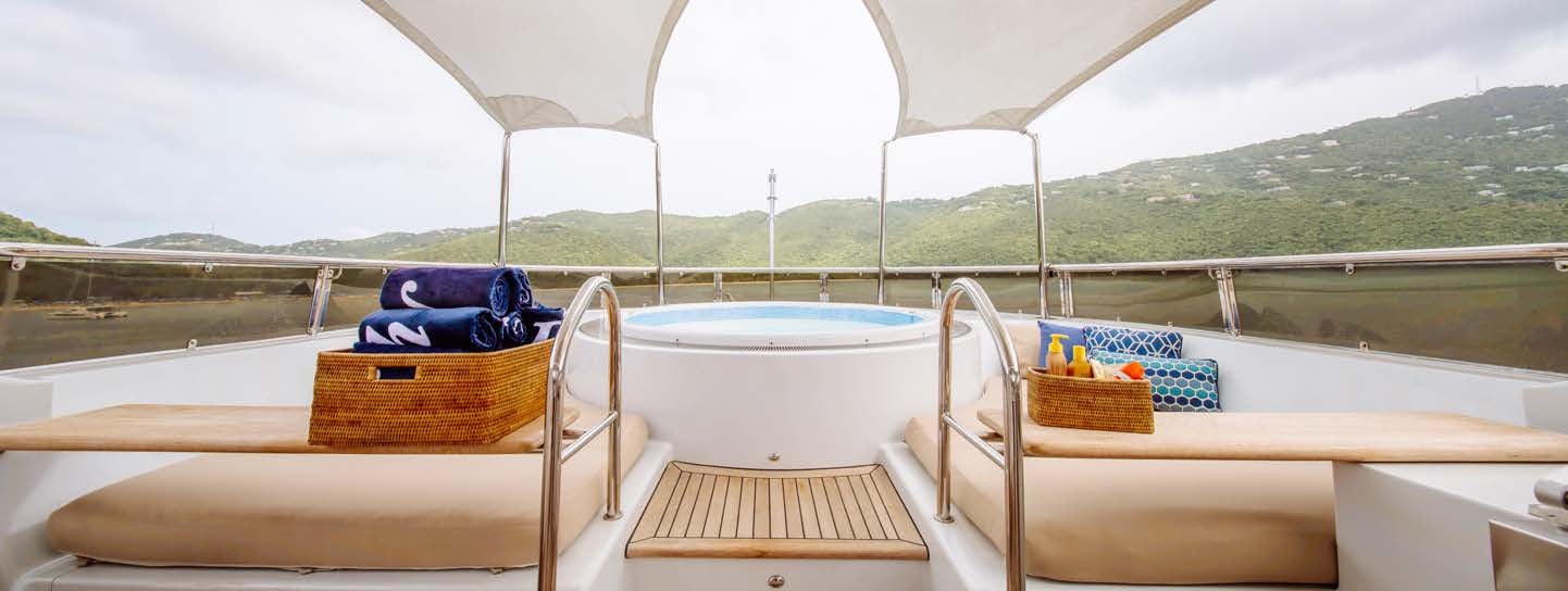 a balcony with a table and chairs aboard JUST ENOUGH Yacht for Charter