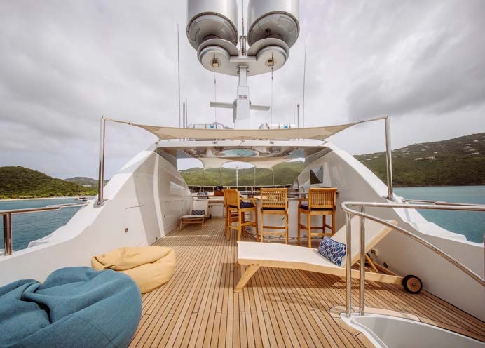a deck with a boat on it aboard JUST ENOUGH Yacht for Charter