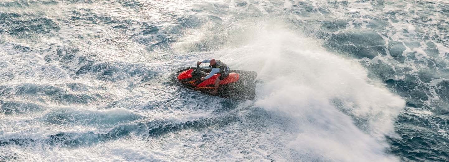 a man riding a jet ski aboard JUST ENOUGH Yacht for Charter
