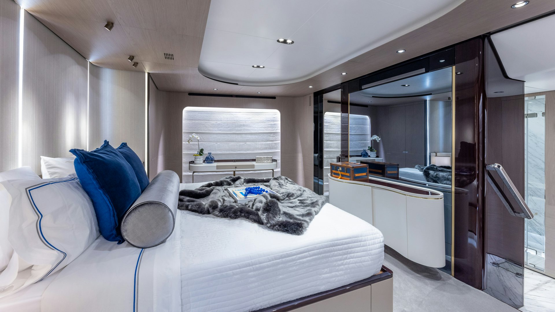 a bedroom with a bed and a desk aboard PIER PRESSURE Yacht for Charter