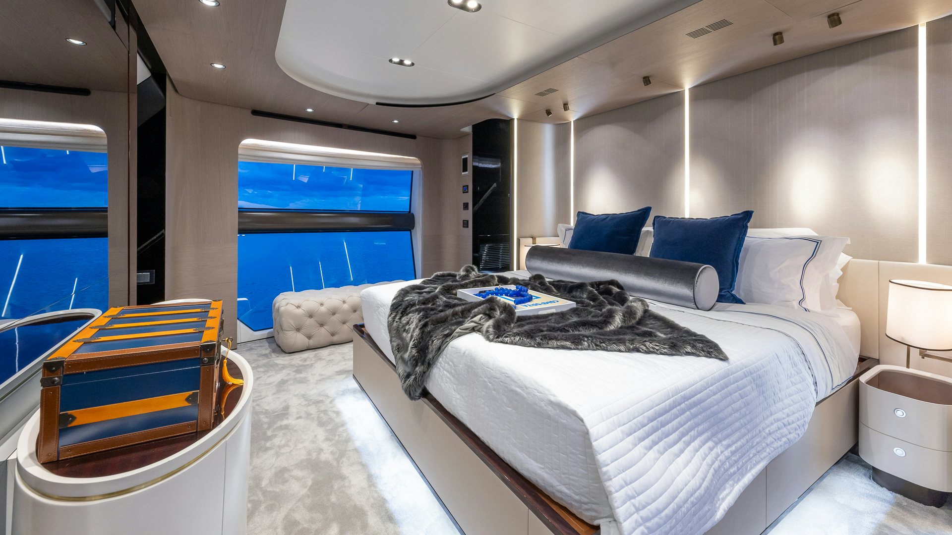 a room with a bed and a chair aboard PIER PRESSURE Yacht for Charter